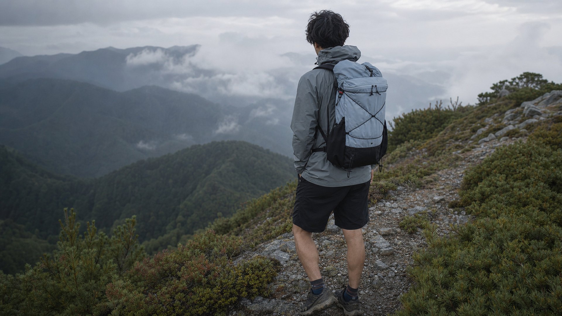 山と道の軽量バックパックとウェアを使用する登山者